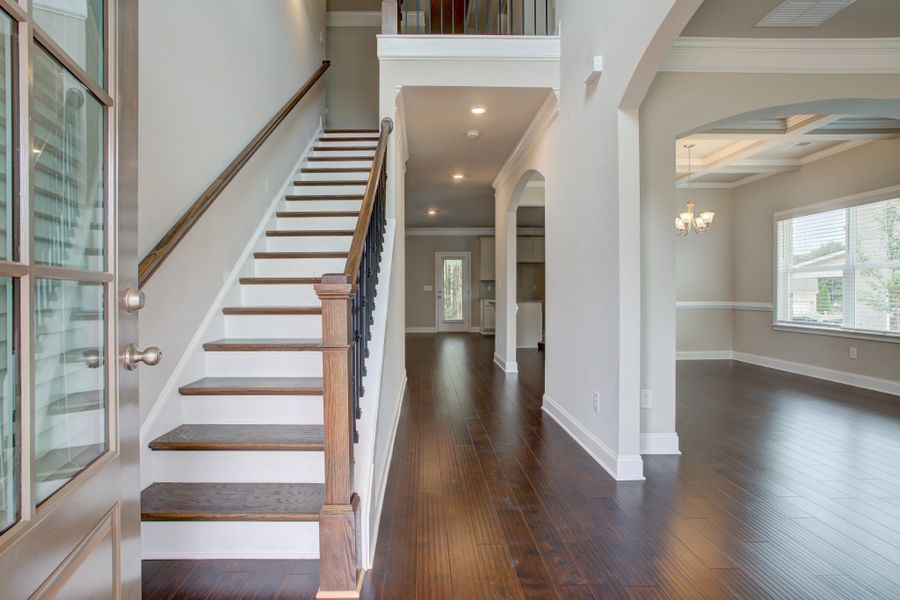 Soaring two-story foyer opens into the front living space or office