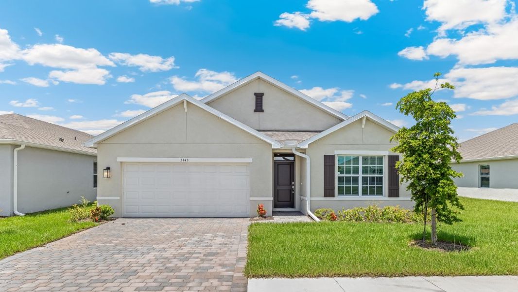 Front exterior of a new home in Brighton Pointe, Fort Myers, FL, highlighting curb appeal (Image 1). Front exterior of a new home in Brighton Pointe, Fort Myers, FL, highlighting curb appeal (Image 1).