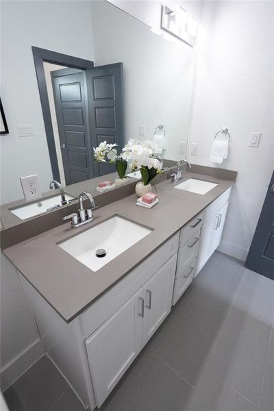 Bathroom featuring tile patterned floors and vanity