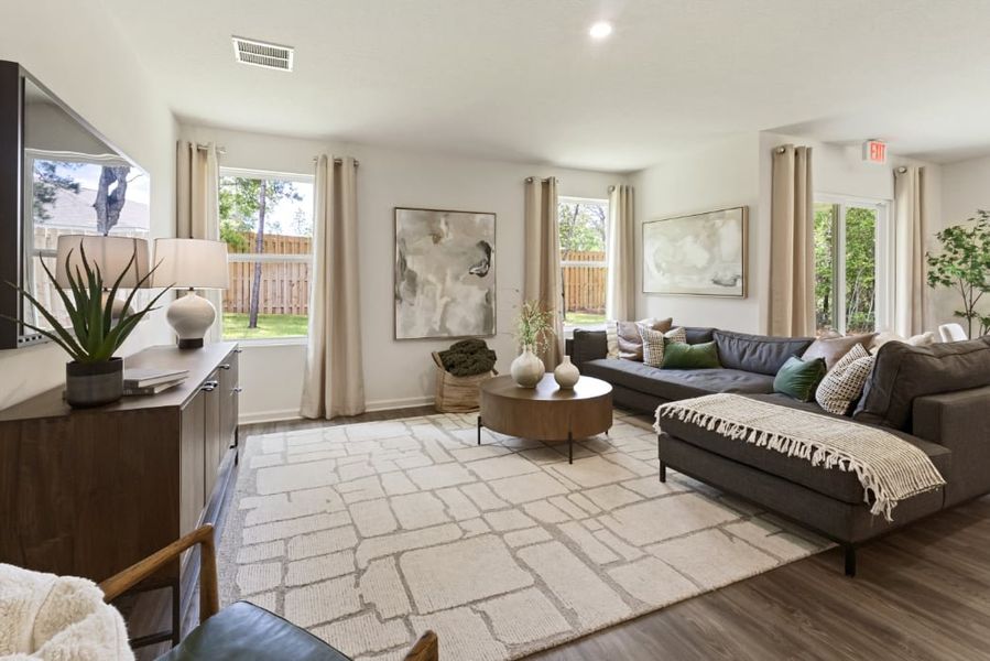 A living room with a couch and a table. A living room with a couch and a table.