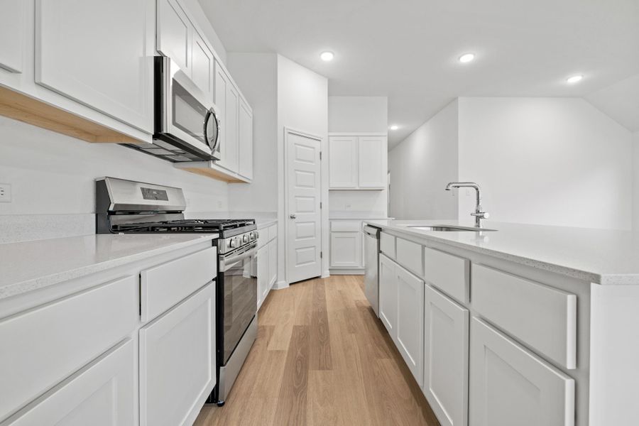 Kitchen in the Quartz home plan by Trophy Signature Homes – REPRESENTATIVE PHOTO