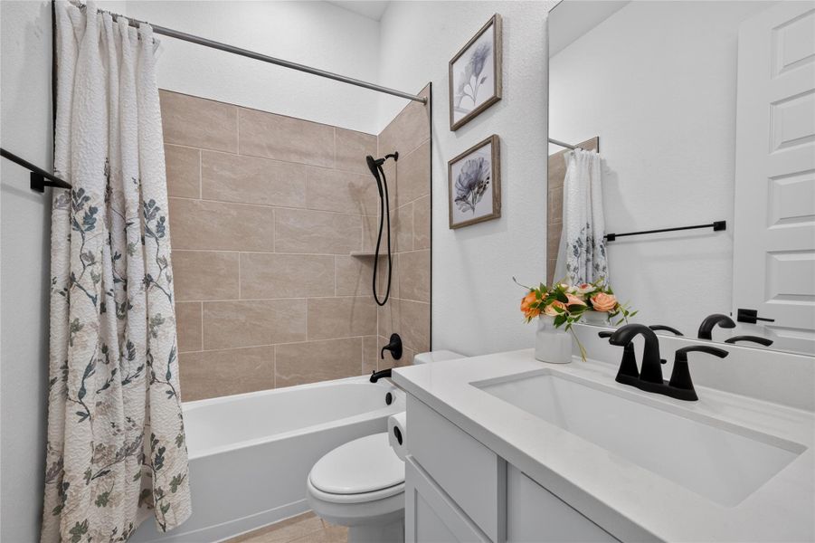 Modern vanity and tiled tub surround highlight this beautifully appointed bathroom. Modern vanity and tiled tub surround highlight this beautifully appointed bathroom.