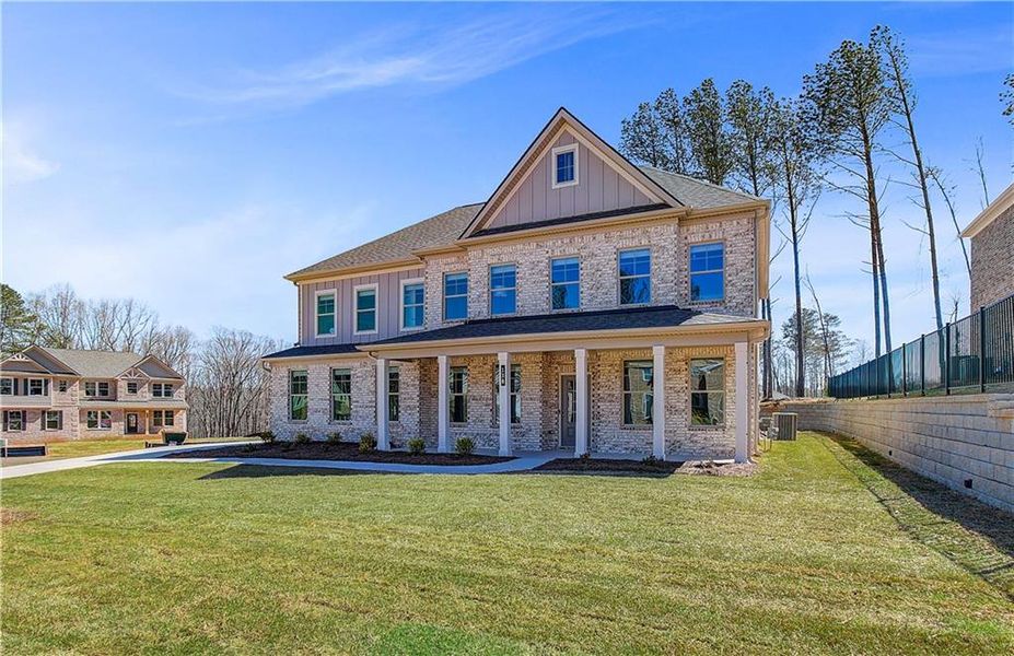 Front exterior of a new home in Cambria at Traditions, Hampton, GA, highlighting curb appeal (Image 21). Front exterior of a new home in Cambria at Traditions, Hampton, GA, highlighting curb appeal (Image 21).