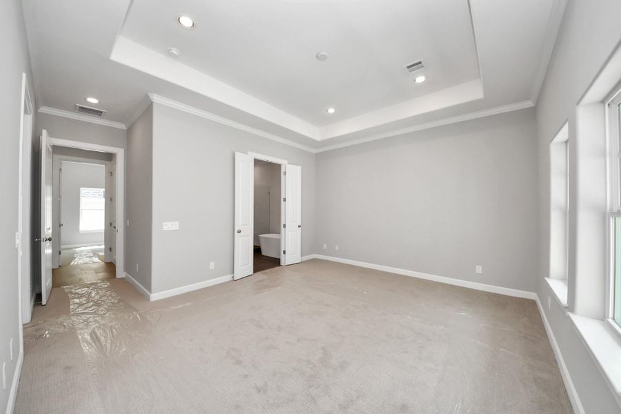 Spacious primary suite featuring recessed lighting and luxury finishes. Spacious primary suite featuring recessed lighting and luxury finishes.