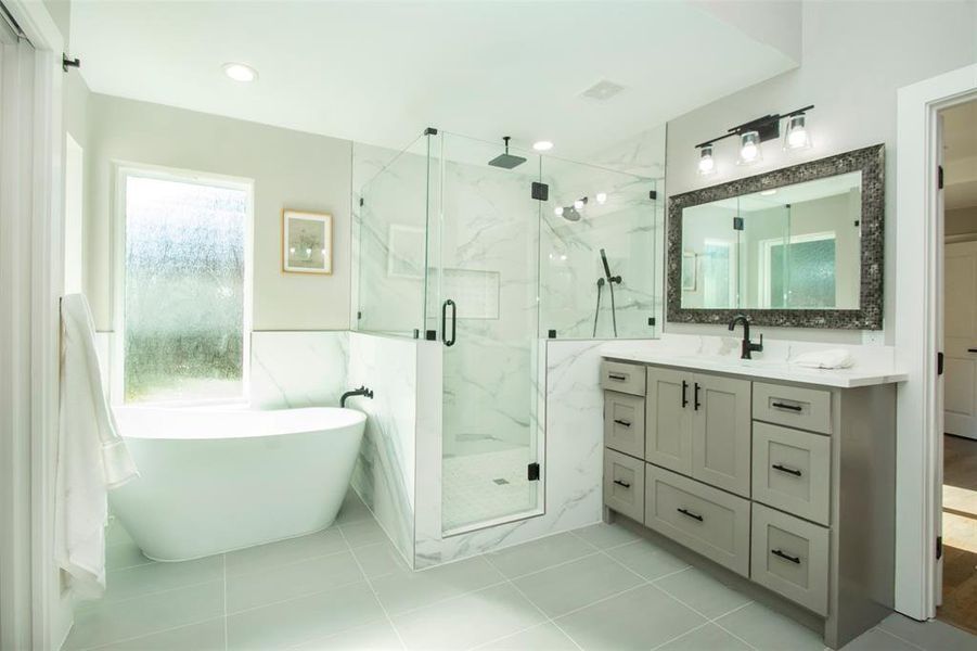 Bathroom featuring a wealth of natural light, vanity, separate shower and tub, and tile patterned flooring