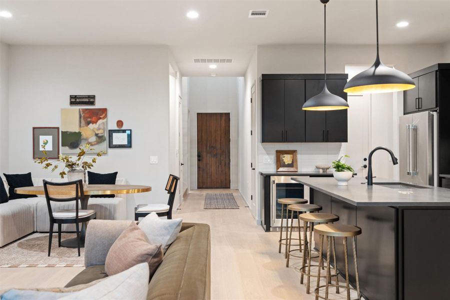 An open floorplan seamlessly connects the contemporary kitchen and dining area. An open floorplan seamlessly connects the contemporary kitchen and dining area.