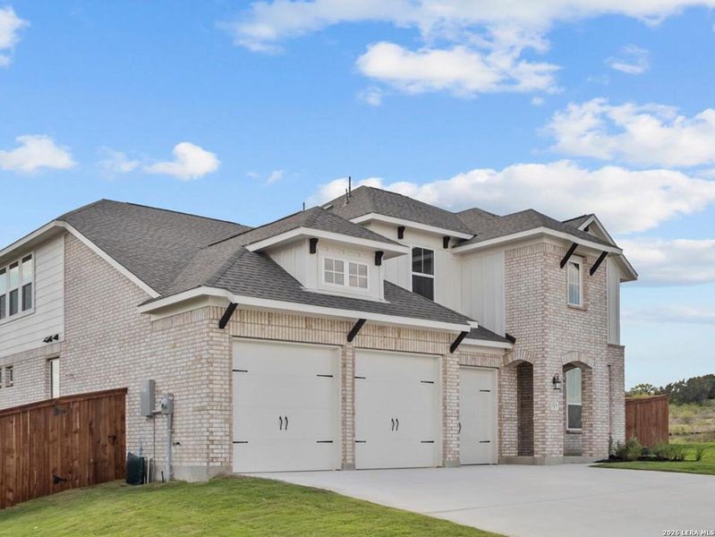 Front exterior of a new home in Homestead, Schertz, TX, highlighting curb appeal (Image 22).