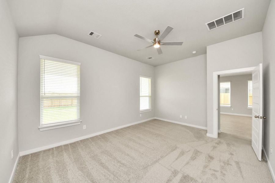 Come and unwind after a long day in this magnificent primary suite! This spacious room features plush carpet, warm paint, high ceilings and large windows with privacy blinds. Sample photo of completed home with similar floor plan. Actual colors and selections may vary. Come and unwind after a long day in this magnificent primary suite! This spacious room features plush carpet, warm paint, high ceilings and large windows with privacy blinds. Sample photo of completed home with similar floor plan. Actual colors and selections may vary.