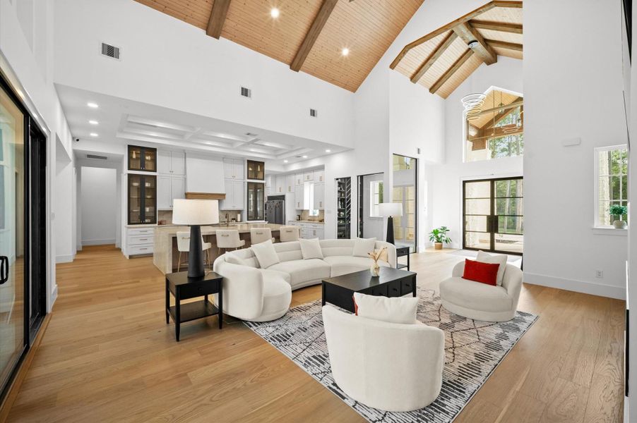 Spacious living room featuring soaring 17-foot vaulted ceilings with stunning wood ceiling accents.
