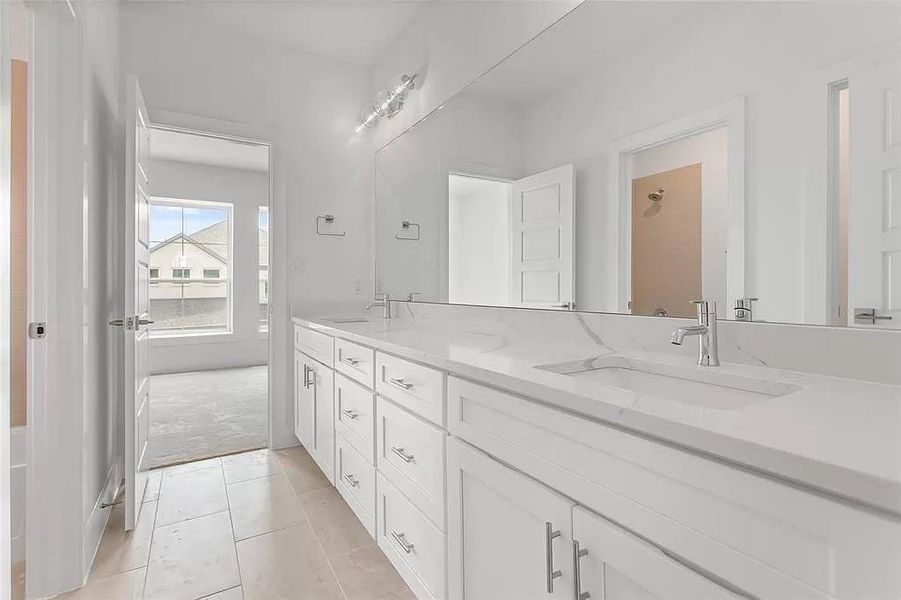 Bathroom with tile patterned floors and dual bowl vanity