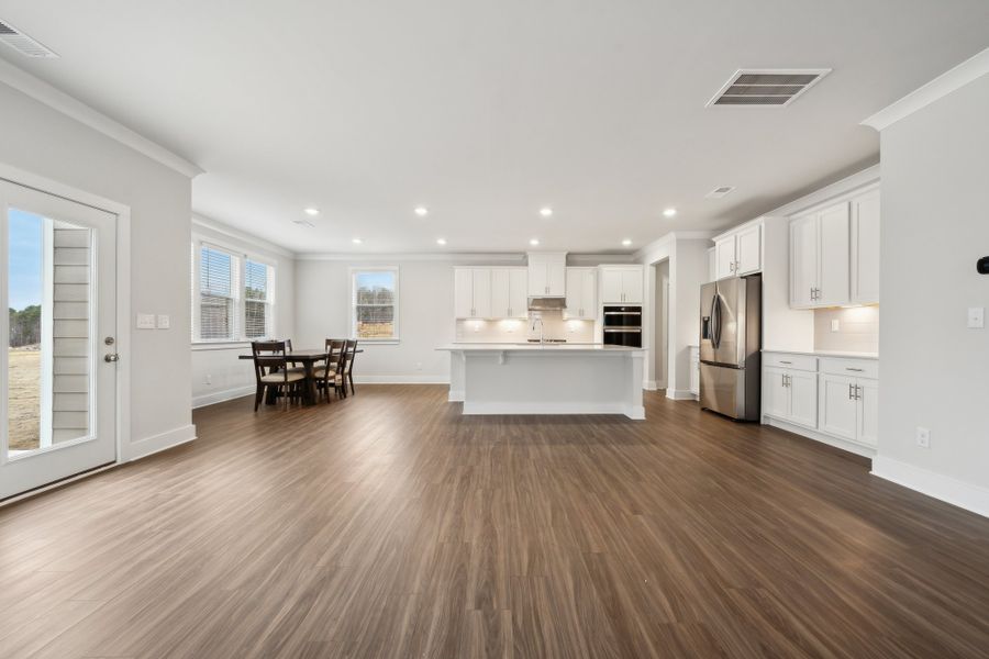 A large kitchen with white cabinets. A large kitchen with white cabinets.
