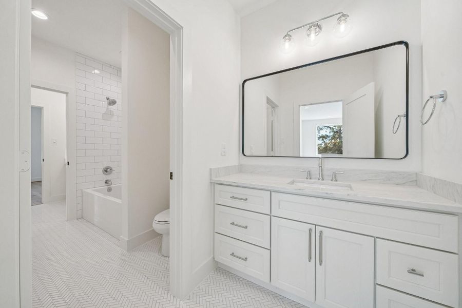 This hollywood bathroom is located in the hallway at the top of the stairs and is shared with the game room and two of the secondary bedrooms.