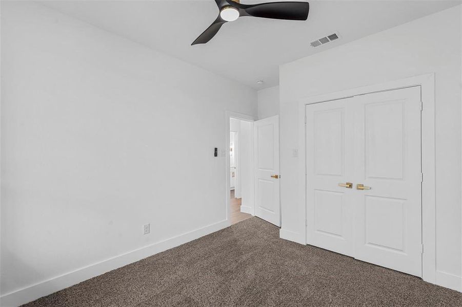 Unfurnished bedroom with carpet and ceiling fan Unfurnished bedroom with carpet and ceiling fan