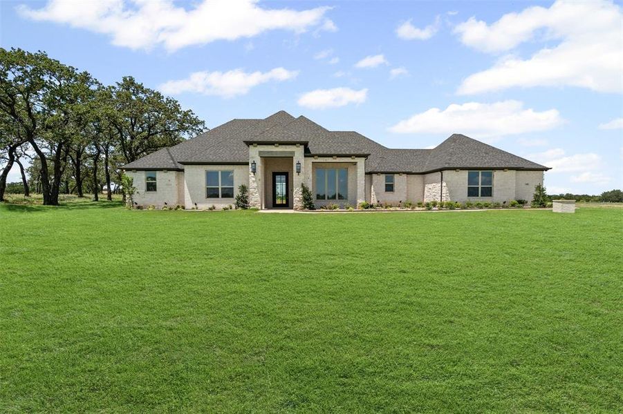 Front exterior of a new home in Santana Ridge, Weatherford, TX, highlighting curb appeal (Image 2). Front exterior of a new home in Santana Ridge, Weatherford, TX, highlighting curb appeal (Image 2).