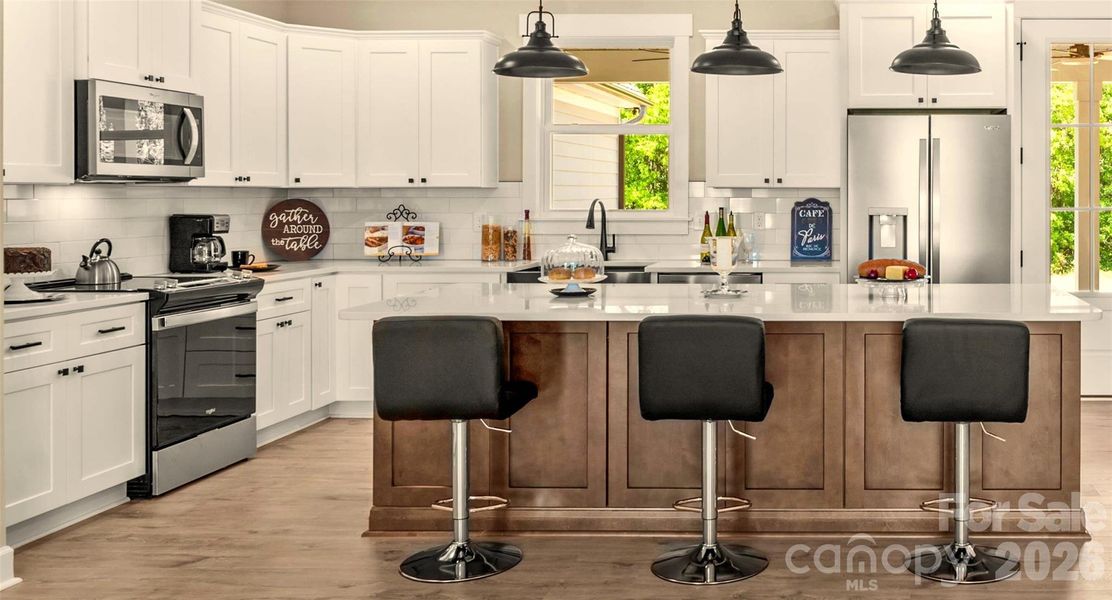 Gournet Kitchen with quartz counters, tile backsplash, huge island and walk in Pantry.