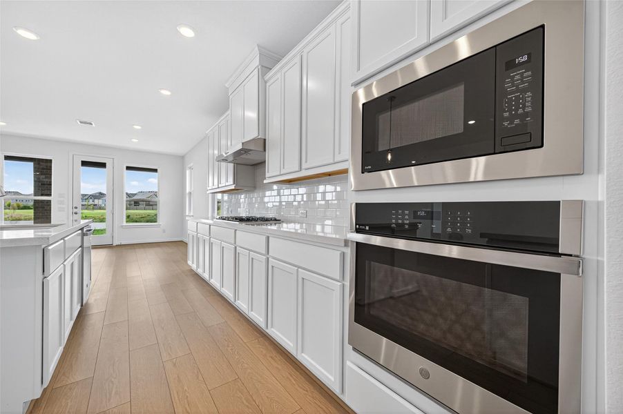 The kitchen is equipped with sleek stainless steel appliances, including a built-in oven, microwave, and gas cooktop, combining modern style with everyday functionality. The kitchen is equipped with sleek stainless steel appliances, including a built-in oven, microwave, and gas cooktop, combining modern style with everyday functionality.