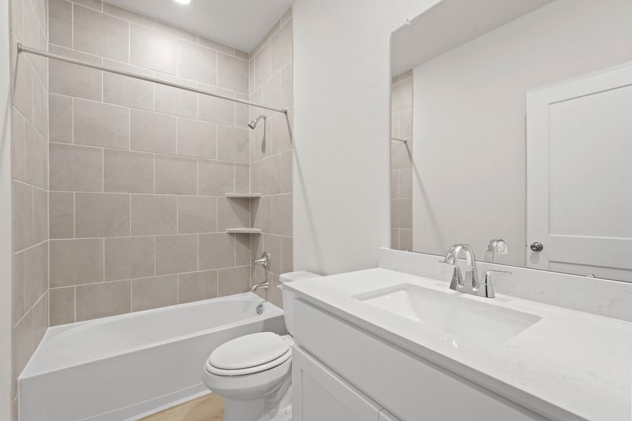 A bathroom with a tub sink and toilet. A bathroom with a tub sink and toilet.