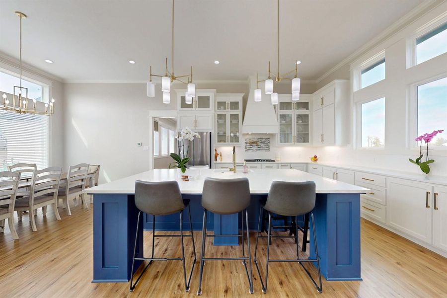 Huge island/breakfast bar.  Notice all the wonderful liight!  Under the counter lighting, canned lights, chandelier, and pemdant lights aren't even needed