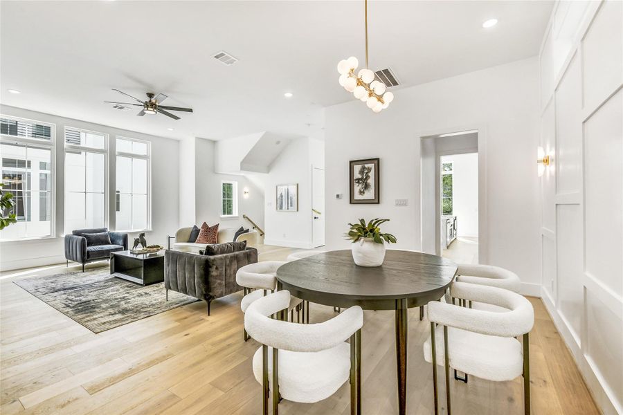 Designed for effortless hosting, this dining space connects fluidly to both the living room and chef’s kitchen, allowing natural conversation and movement during gatherings. High ceilings and symmetry amplify the sense of openness, while soft lighting enhances the home’s elevated ambiance—a perfect blend of form and functionality for today’s busy medical or executive lifestyle.