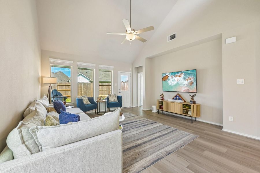 Spacious living room with high ceilings, abundant natural light from large windows, and modern finishes.