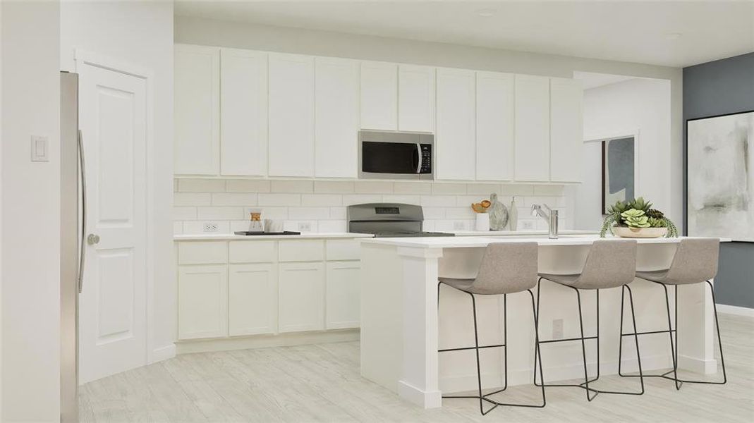 Kitchen featuring an island with sink, backsplash, stainless steel appliances, a breakfast bar area, and white cabinetry Kitchen featuring an island with sink, backsplash, stainless steel appliances, a breakfast bar area, and white cabinetry