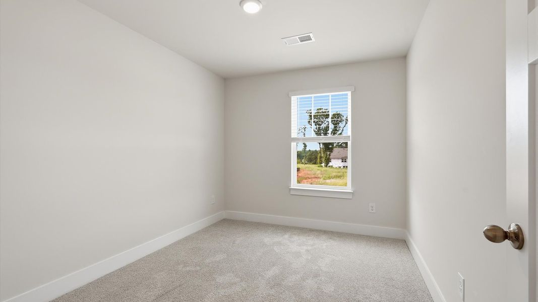 Highly functional bedroom with large windows, carpeted flooring, and tasteful finishes throughout near Anderson University