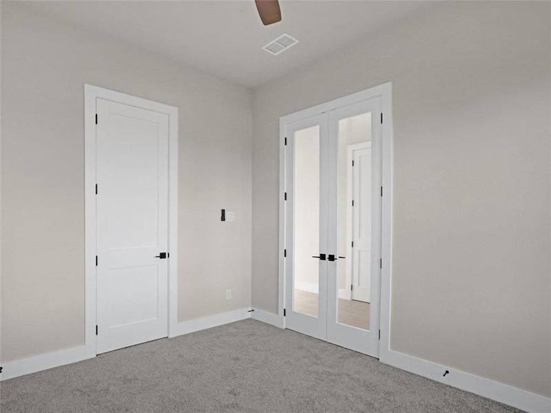 Study featuring light colored carpet, french doors, and ceiling fan