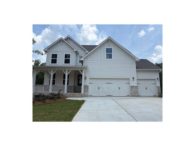 Front exterior of a new home in Riverwood, Dallas, GA, highlighting curb appeal (Image 1).