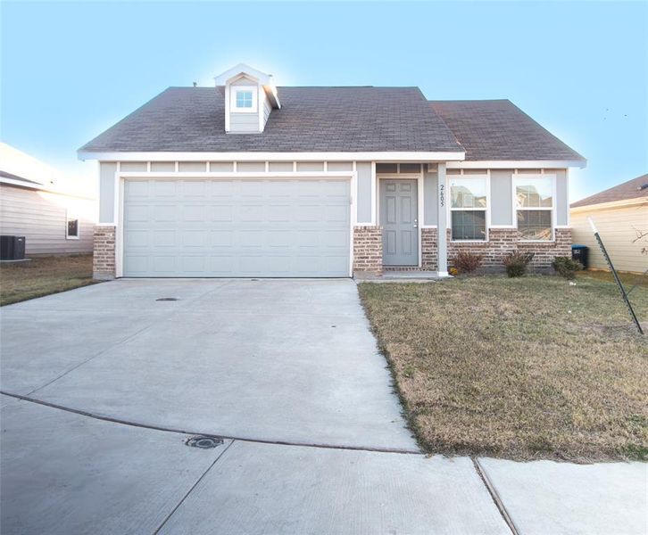 View of front of house with a front lawn and a garage