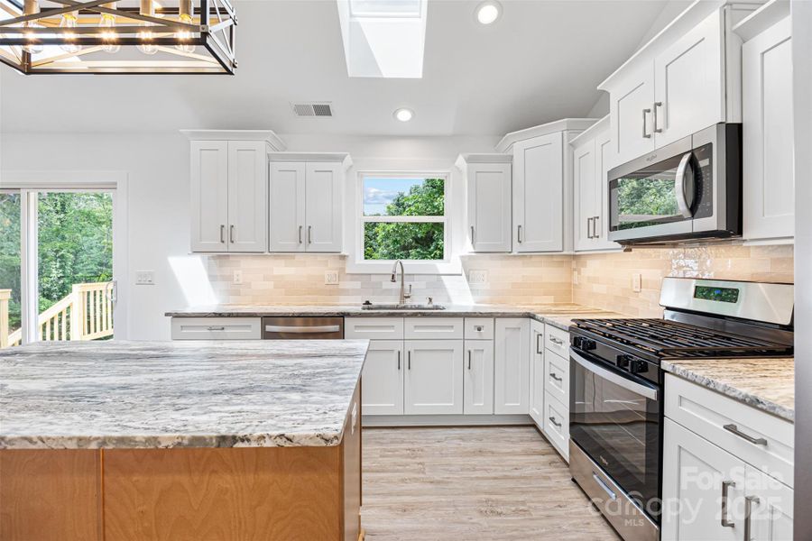 Kitchen with leathered granite countertops