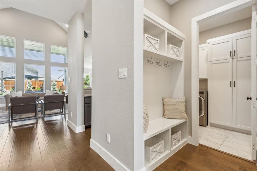 Mudroom with hardwood / wood-style floors and vaulted ceiling