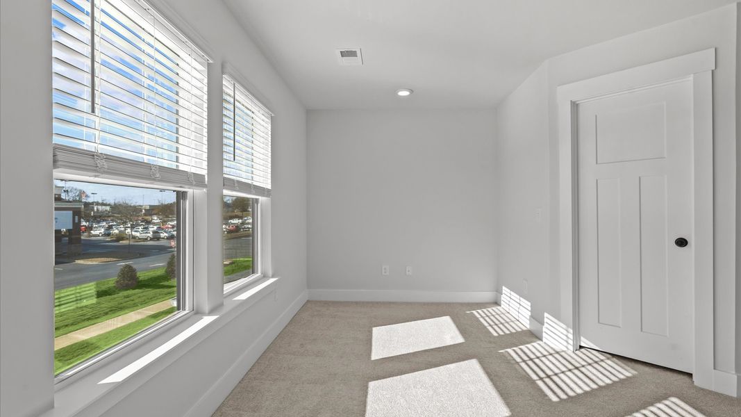 Vibrant natural light fills this exceptional primary suite with eye-catching details