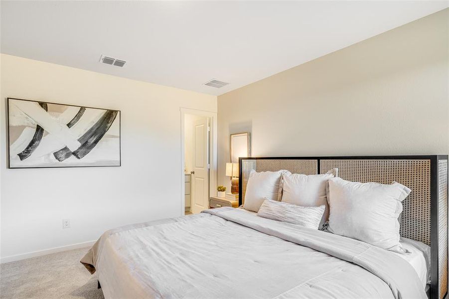 Bedroom featuring light carpet