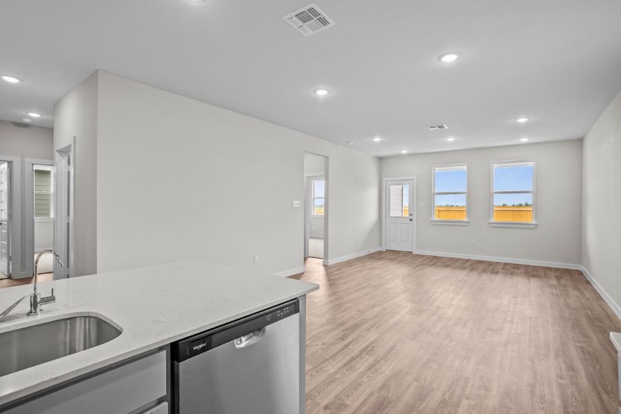 A kitchen with a wood floor.