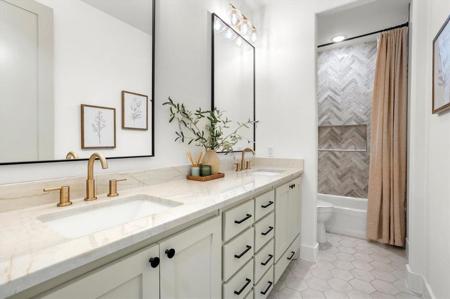 Full bathroom with tile patterned flooring, vanity, shower / tub combo, and toilet