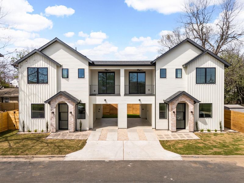 Modern farmhouse style home with a balcony, board and batten siding, and concrete driveway
