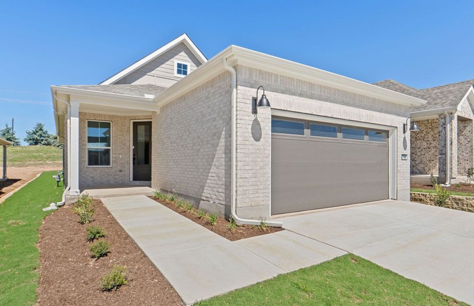 Front exterior of a new home in Sun City Texas, Georgetown, TX, highlighting curb appeal (Image 21).