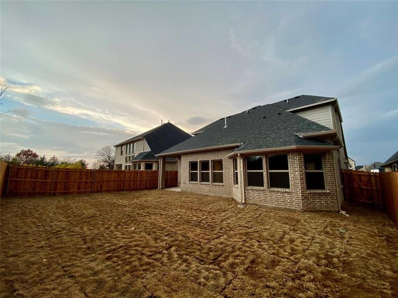 View of back house with 100% brick and covered patio