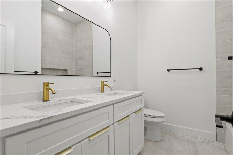 Bathroom featuring double vanity and light tile patterned floors