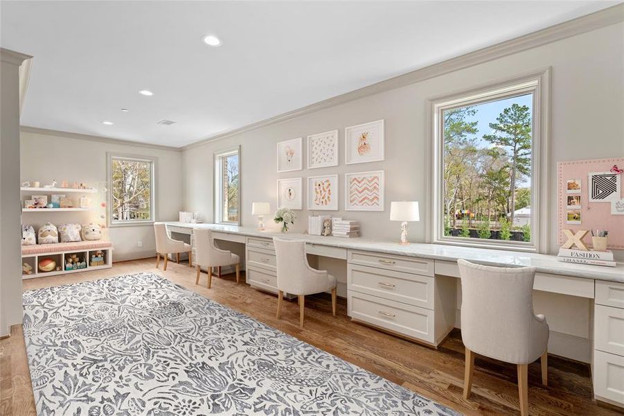 This upstairs study/playroom earns high marks for its built-in desks with quartzite tops, abundant storage and large windows.