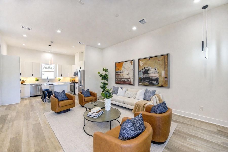 Second-floor living space with an open-concept layout suitable for gathering and entertaining. (Refrigerator shown is virtually staged)