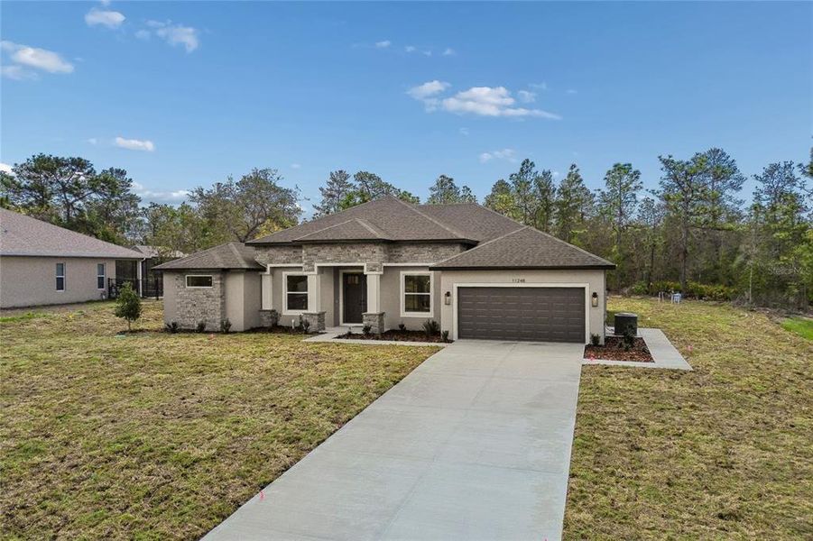 Front exterior of a new home in , Weeki Wachee, FL, highlighting curb appeal (Image 30). Front exterior of a new home in , Weeki Wachee, FL, highlighting curb appeal (Image 30).