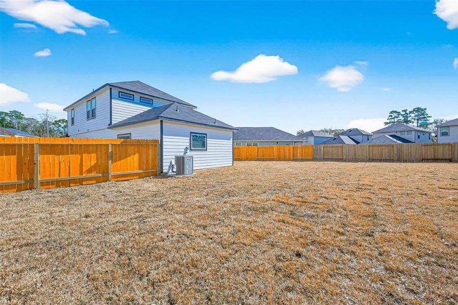Exterior details and patio area of a home in Woodland Lakes, Huffman (Image 21).