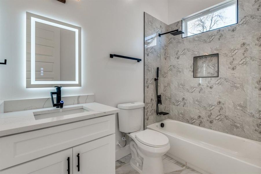 Well-appointed guest bathroom with illuminated anti-fog mirrors and a multi-head shower for a luxurious experience. Well-appointed guest bathroom with illuminated anti-fog mirrors and a multi-head shower for a luxurious experience.