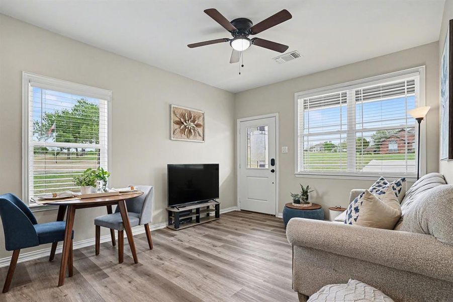 Separate Access Living room featuring light wood-style flooring and ceiling fan
