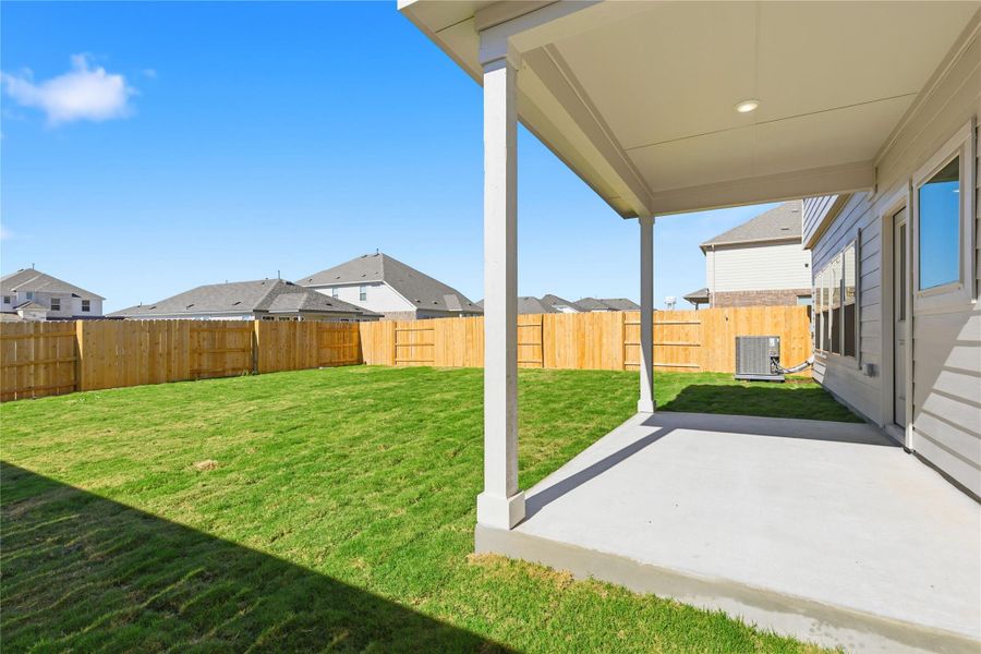 Fenced backyard featuring a patio and a residential view
