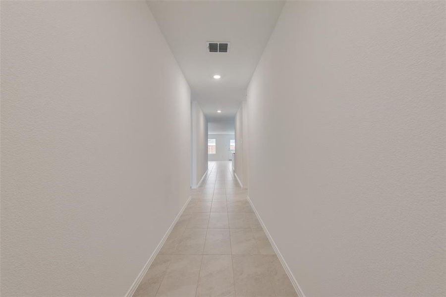 Corridor featuring light tile patterned flooring