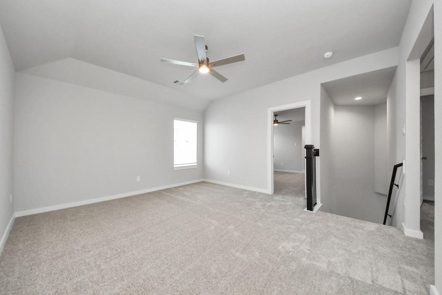 Come upstairs and enjoy a day of leisure in this fabulous game room! This is the perfect hangout spot or adult game room! Features plush carpet, high ceilings, custom paint and windows for plenty of natural light. Sample photo of completed home with similar floor plan. Actual colors and selections may vary. Come upstairs and enjoy a day of leisure in this fabulous game room! This is the perfect hangout spot or adult game room! Features plush carpet, high ceilings, custom paint and windows for plenty of natural light. Sample photo of completed home with similar floor plan. Actual colors and selections may vary.