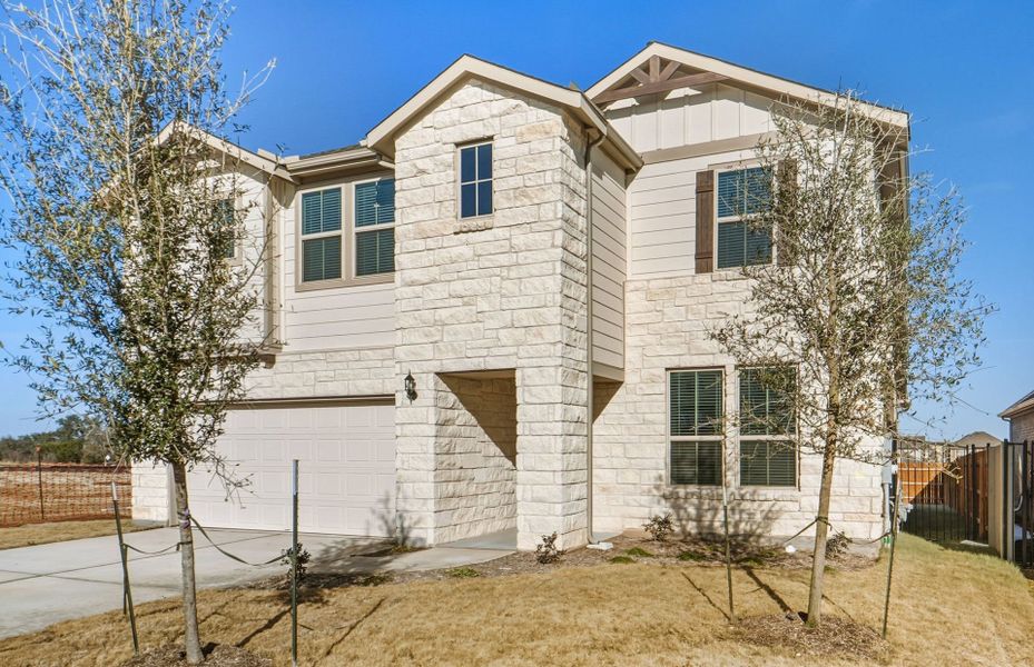 Front exterior of a new home in Saddleback at Santa Rita Ranch, Liberty Hill, TX, highlighting curb appeal (Image 24).