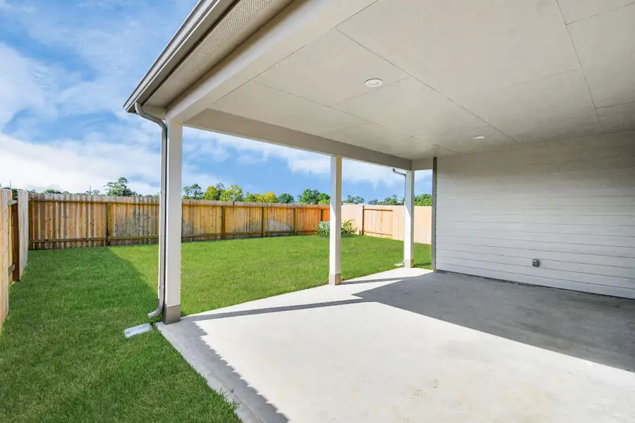 Experience outdoor living at its finest on this expansive covered patio, thoughtfully designed for BBQs and delightful outdoor dining.